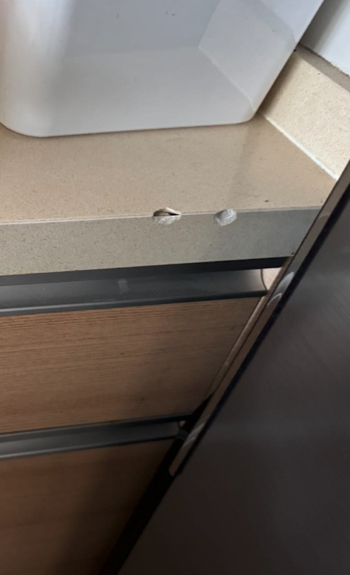 Localized chips at the corner edge of a residential countertop