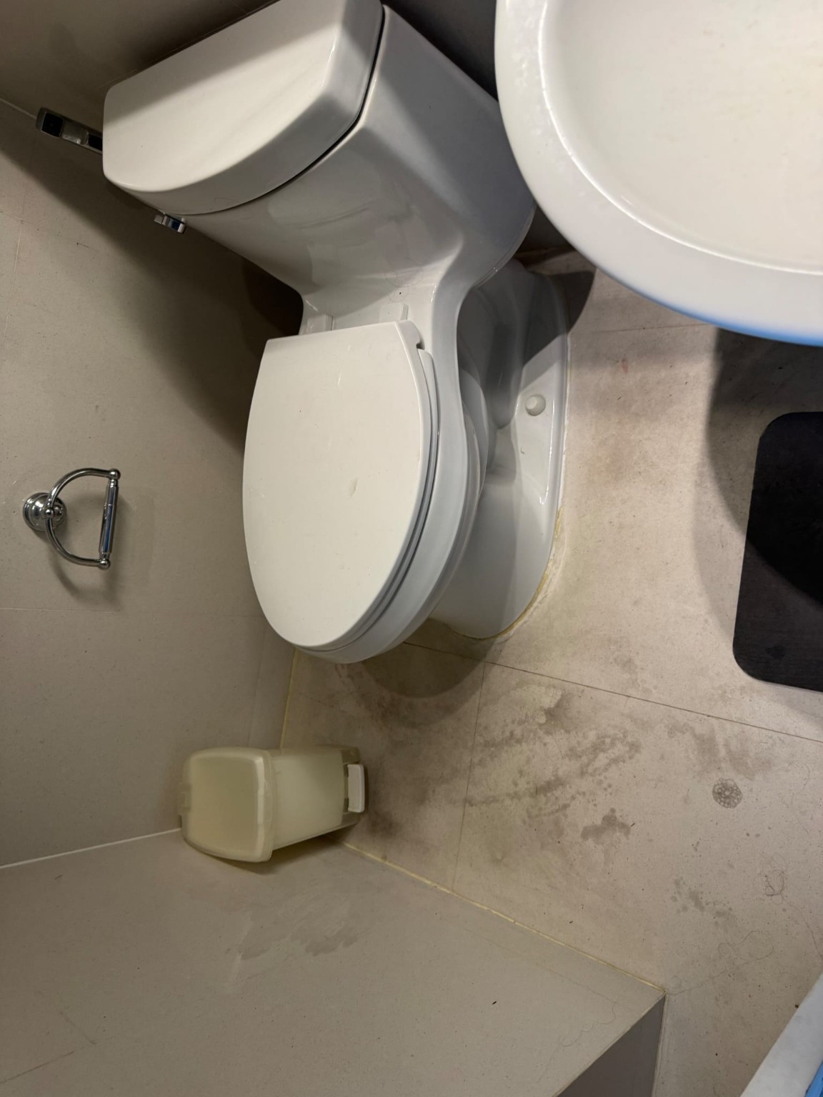Localized discoloration on the toilet room floor
